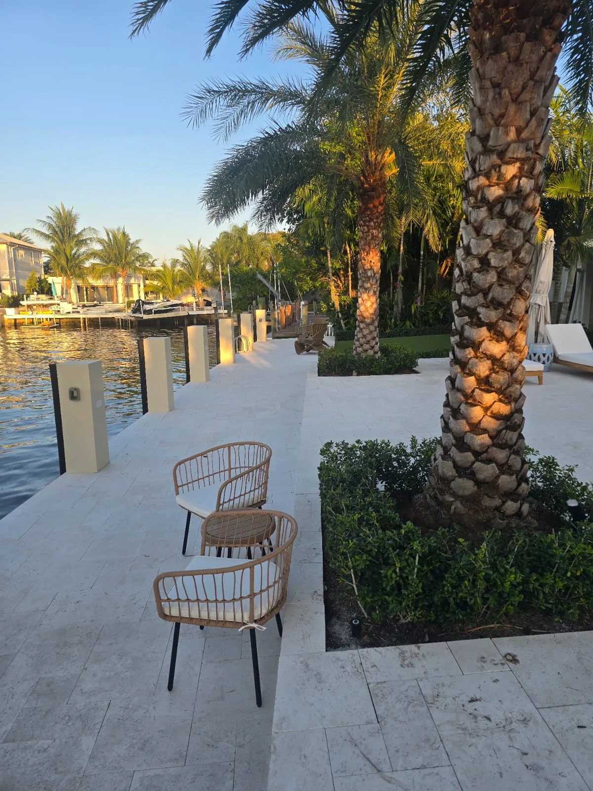 Coastal dockside patio and landscaping along a Lighthouse Point canal